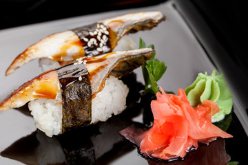 Japanese national popular cuisine. Sushi, rice and fish. Tasty, beautifully served food in a restaurant, cafe, with elements of the original design.