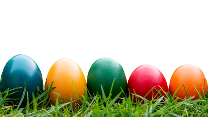 Easter background. Colorful eggs and green grass isolated. White background for copy space.