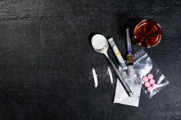 Money and drugs. syringe with heroin. scattered pills. Copyspace.