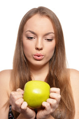 Portrait of beautiful young woman with green apple