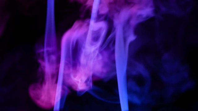 abstract red and blue smoke blow out and mixing at dark background
