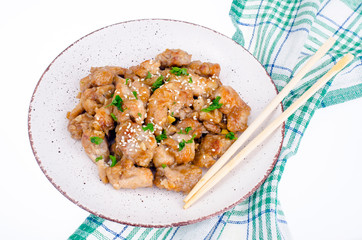 Plate with slices of chicken in batter with sesame seeds