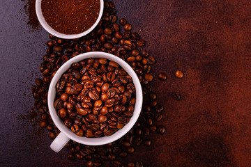 Seeds of fragrant coffee, coffee drink on a dark concrete background. It can be used as a background