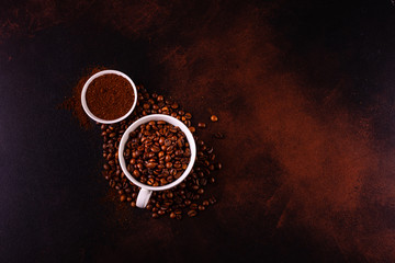 Seeds of fragrant coffee, coffee drink on a dark concrete background. It can be used as a background