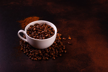 Seeds of fragrant coffee, coffee drink on a dark concrete background. It can be used as a background