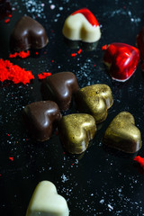 chocolate hearts on the black background
