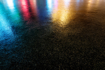 Wet colored asphalt. Road texture.