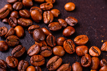 Seeds of fragrant coffee, coffee drink on a dark concrete background. It can be used as a background