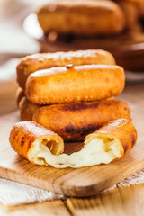 Cheese fingers, typical Venezuelan appetizer called tequeños  on a wooden board