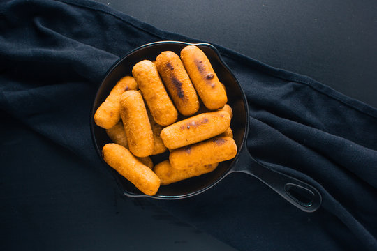 Top view of Cheese fingers inside a black pan ready to eat