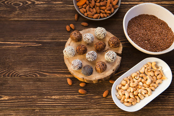 the vegan of handmade candy and ingredients on a wooden background. Fitness sweets. candies without sugar. vegan snack.
