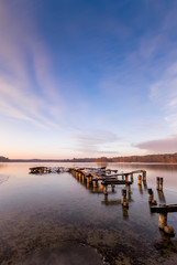 Obraz premium An old pier on the lake just before sunset in winter