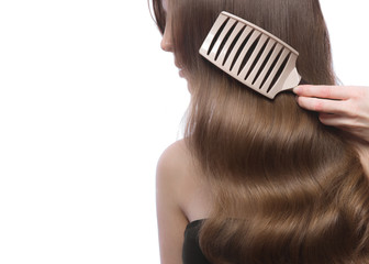 Fototapeta premium Beautiful brown-haired girl in move with a perfectly curls hair, and classic make-up. Beauty face.