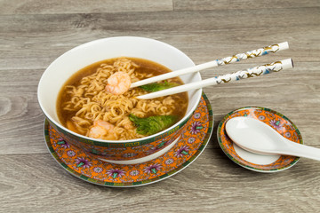 Eating Shrimp and Noodle in Oriental Setting with Chopsticks and Soup Spoon