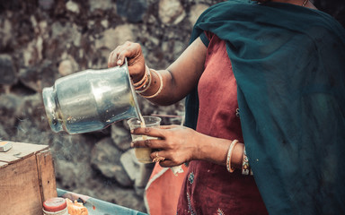 woman pours cane syrup from a jug
