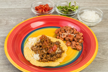Making Mexican Chalupa Dinner on Colorful Plate