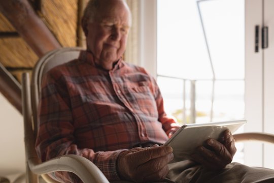 Senior man using laptop in living room