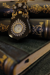 Vintage pocket Watch on a pile of old books.