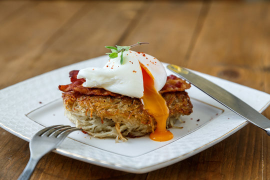 Potato rosti, poached egg with runy yolk and bacon on top.