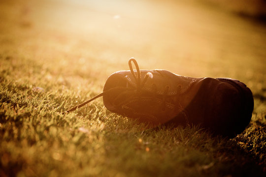 Old boots abandoned in grass