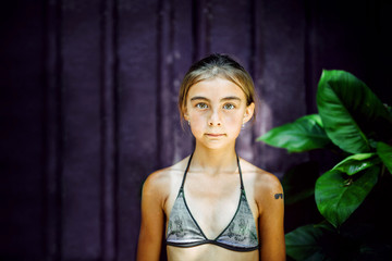 Portrait of girl in bikini top standing outdoors