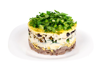 Portion salad with tongue on white plate