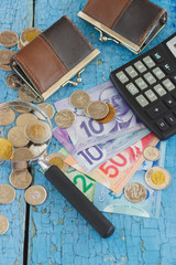 Canadian dollars, coins, wallets and calculator on the wooden background, blurred background