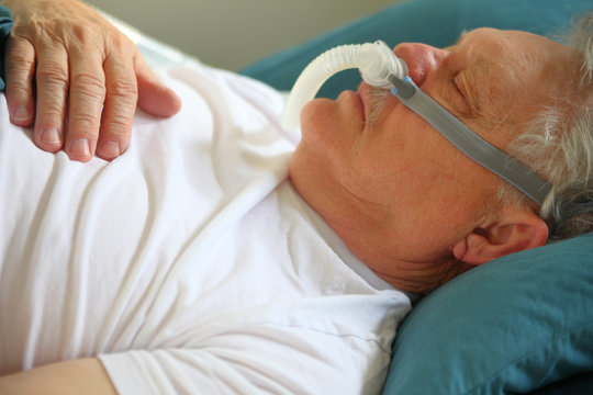 A man with breathing problems uses a CPAP while sleeping