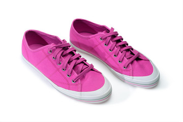 Pair of pink gumshoes. Fuchsia sneakers isolated on a white