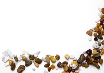 Different stones placed out as a frame on white background