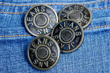 Metal buttons with inscription Jeans on a denim