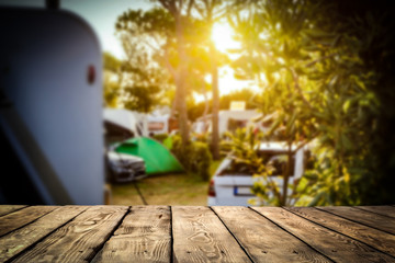 A campsite in a sunny place with a wooden board for an advertising product    - obrazy, fototapety, plakaty