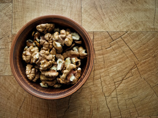 Peeled walnuts in a plate of clay.