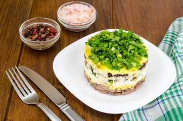 Layered portion salad with meat, cucumber, egg and mayonnaise
