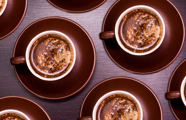 A cup of delicious coffee on a dark background