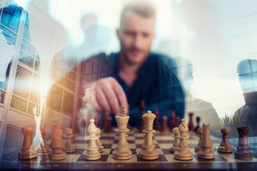 Businessman play with chess game. concept of business strategy and tactic. Double exposure