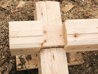 the beginning of the construction of a wooden house. The bar is profiled and falls into the groove. Laying in the corner