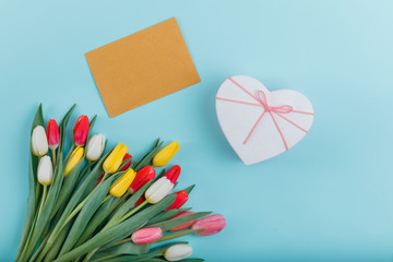 Spring tulips frame on background, top view.