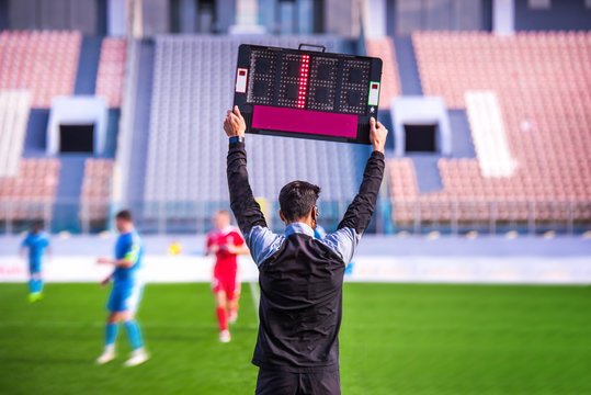 Referee holds the table for additional time. Football, soccer photo