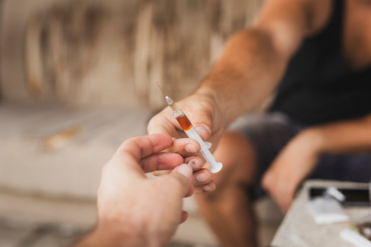 Intravenous Drug Users Sharing A Syringe