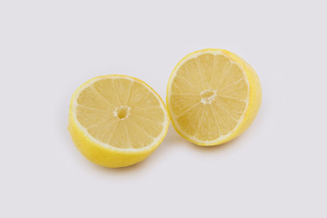 Two halves of a cut lemon on a white background. Close-up photo