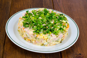 Vegetable salad with sausage and canned green peas