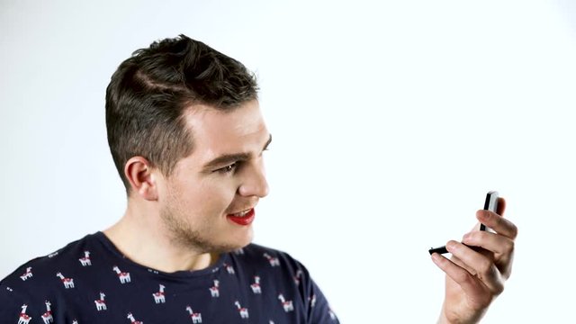 A man gay does makeup. He is combing his eyebrows. 4k