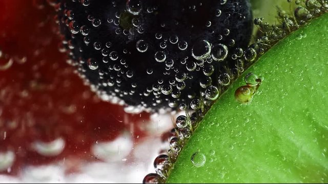 fresh fruits in the water with drops of water