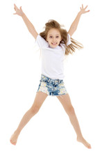 A little girl in a pure white t-shirt is jumping. The concept of