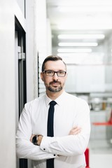 Middle aged handsome manager businessman in white shirt at office