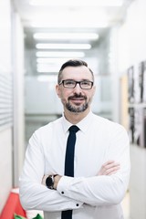 Middle aged handsome manager businessman in white shirt at office