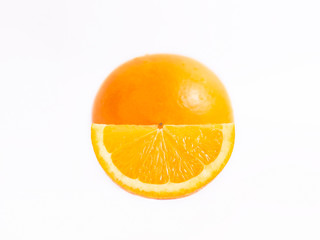 Juicy fresh orange in front of him a slice of orange. Close photo