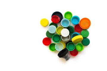 Various colorful plastic screw caps isolated on the white background. Plastic processing for ecology or charity.