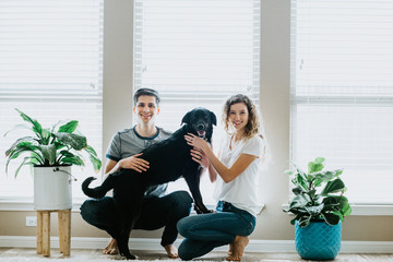 Happy Couple with dog at home